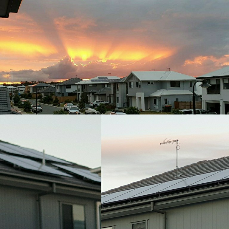 solar panels on houses with sunrise